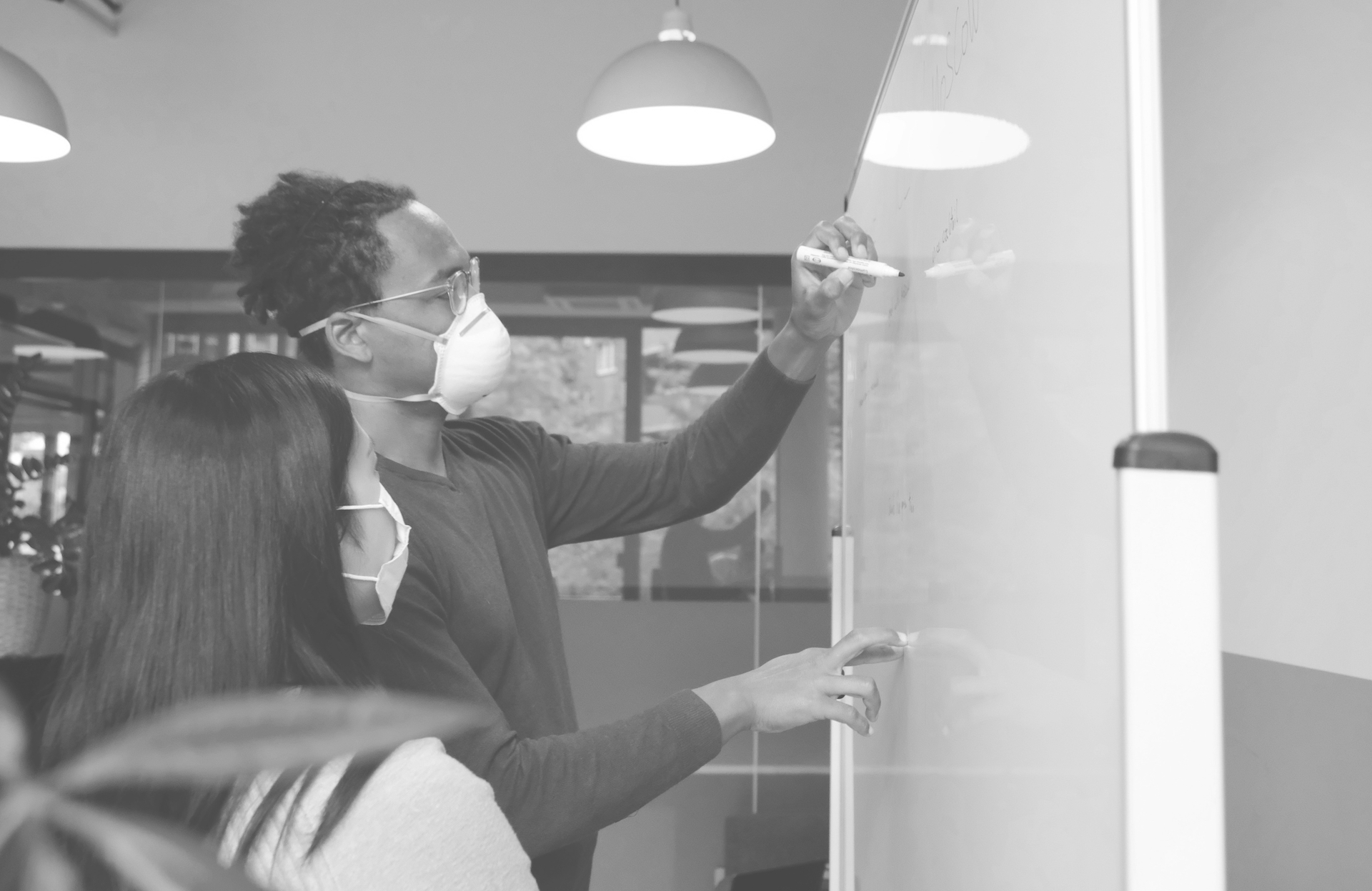 airfocus-MyXr1AbAjJU-unsplash People at a whiteboard having a discussion